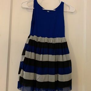 Sleeveless dress with striped petticoat.